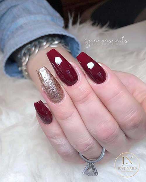 maroon and gold glitter nail design